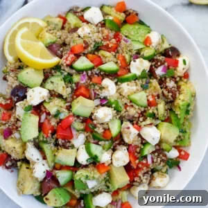 Vibrant Mediterranean Quinoa Salad 7 Easy Mediterranean Quinoa Salad in a white bowl, showcasing its fresh ingredients and vibrant colors.