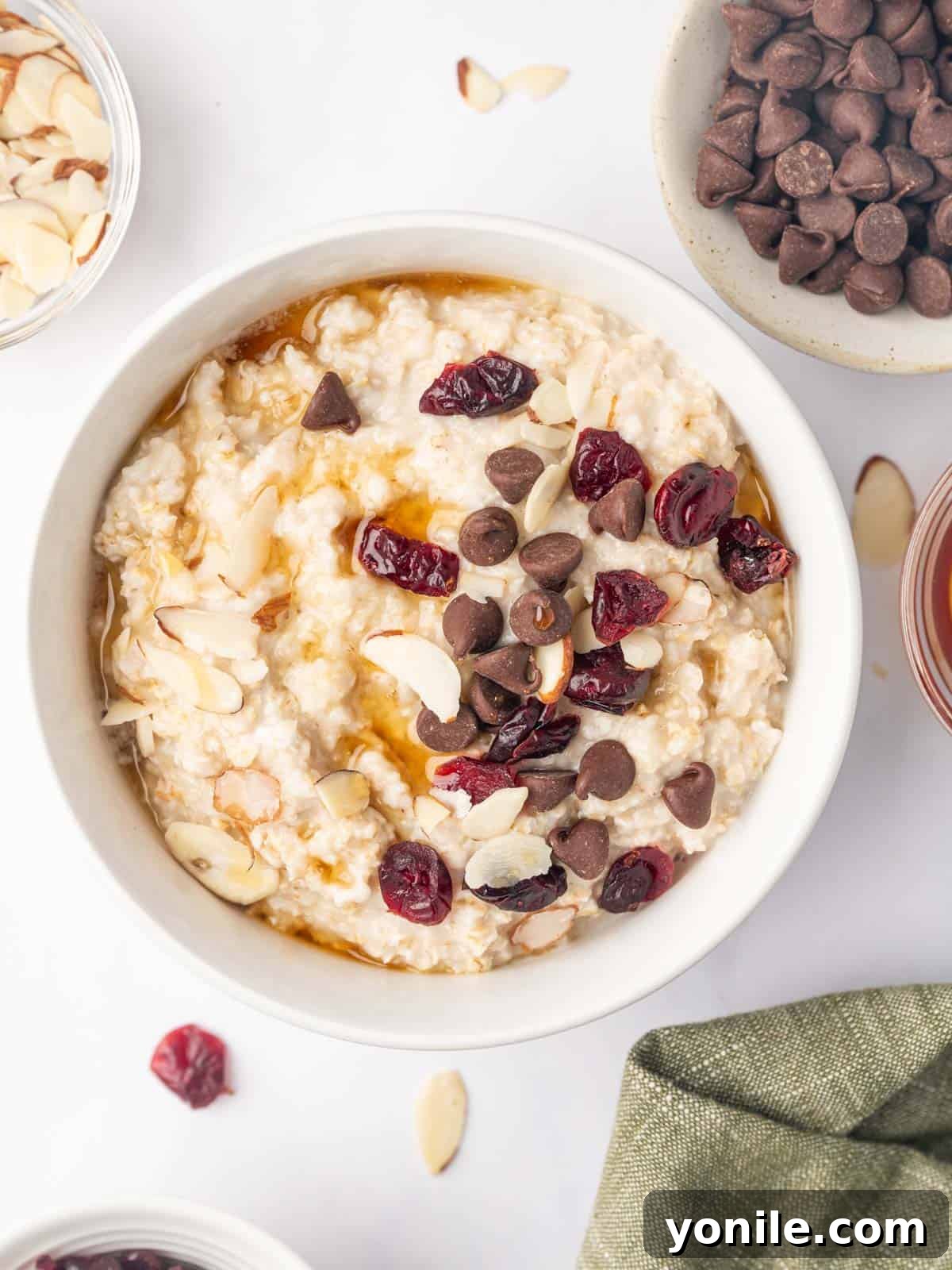 Perfect Oatmeal Every Time 7 Microwaved rolled oats in a bowl topped with chocolate chips and nuts.
