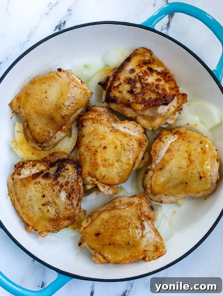 Hearty Chicken and Potato Bake 4 Overhead shot of chicken thighs marinating in a bowl