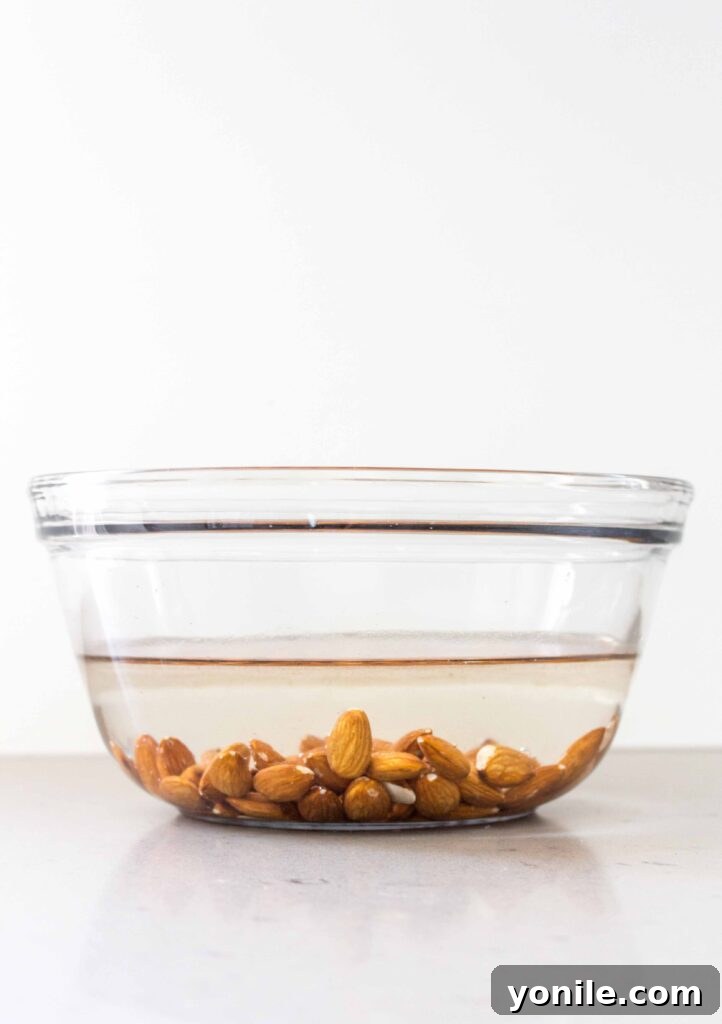 almonds soaking in water in a glass bowl