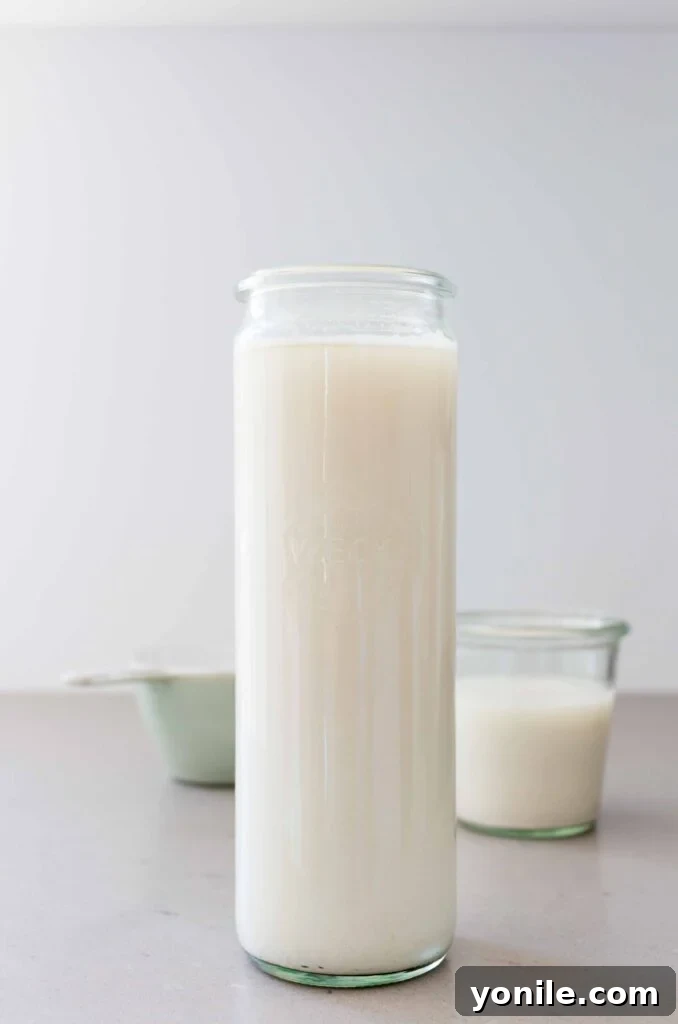 A glass bottle of freshly made homemade oat milk, chilled and ready to serve
