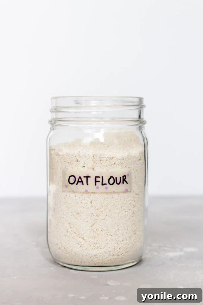 A close-up shot of a bowl filled with finely ground oat flour, ready for use in baking.