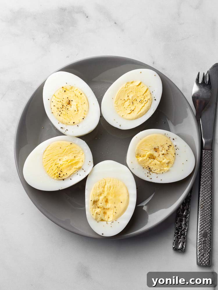 Hard-boiled eggs, sliced and seasoned with fresh pepper, ready to eat.