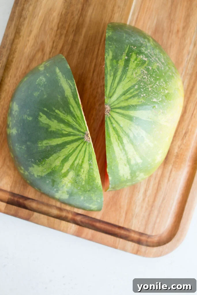 Slice Watermelon Like a Pro 5 A watermelon cut into quarters, showing the interior of the fruit.