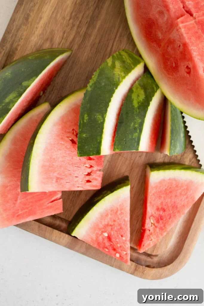 Slice Watermelon Like a Pro 7 A platter filled with freshly cut watermelon triangles, vibrant red and ready to eat.