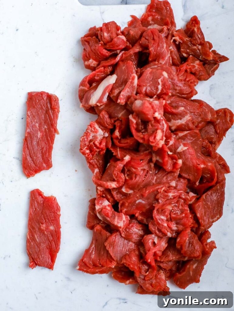 sliced beef on a counter top, ready for cooking