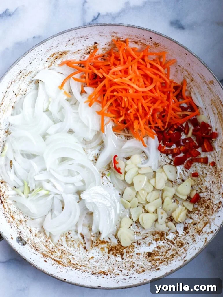 carrots, onions, garlic, and chili in a bowl, prepped for stir fry