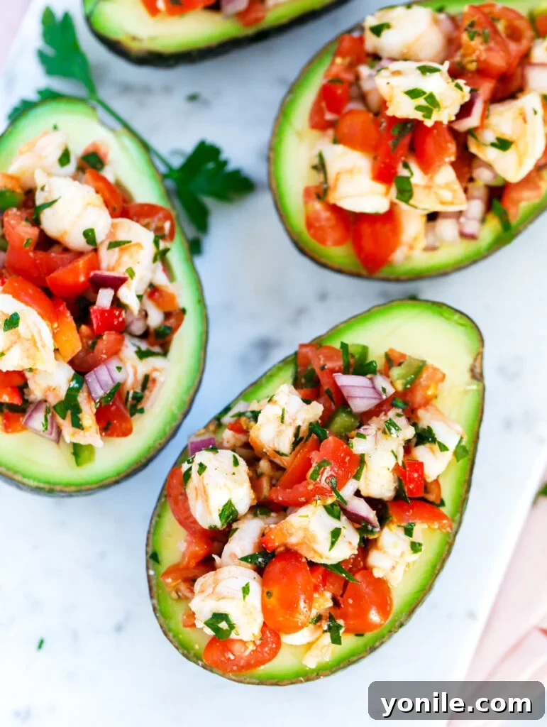 top down shot of Healthy Shrimp Stuffed Avocados served in a dish, showcasing the vibrant filling.