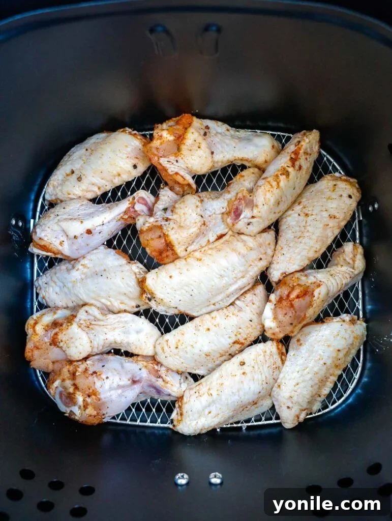 Air Fryer Chicken Wings in air fryer basket.