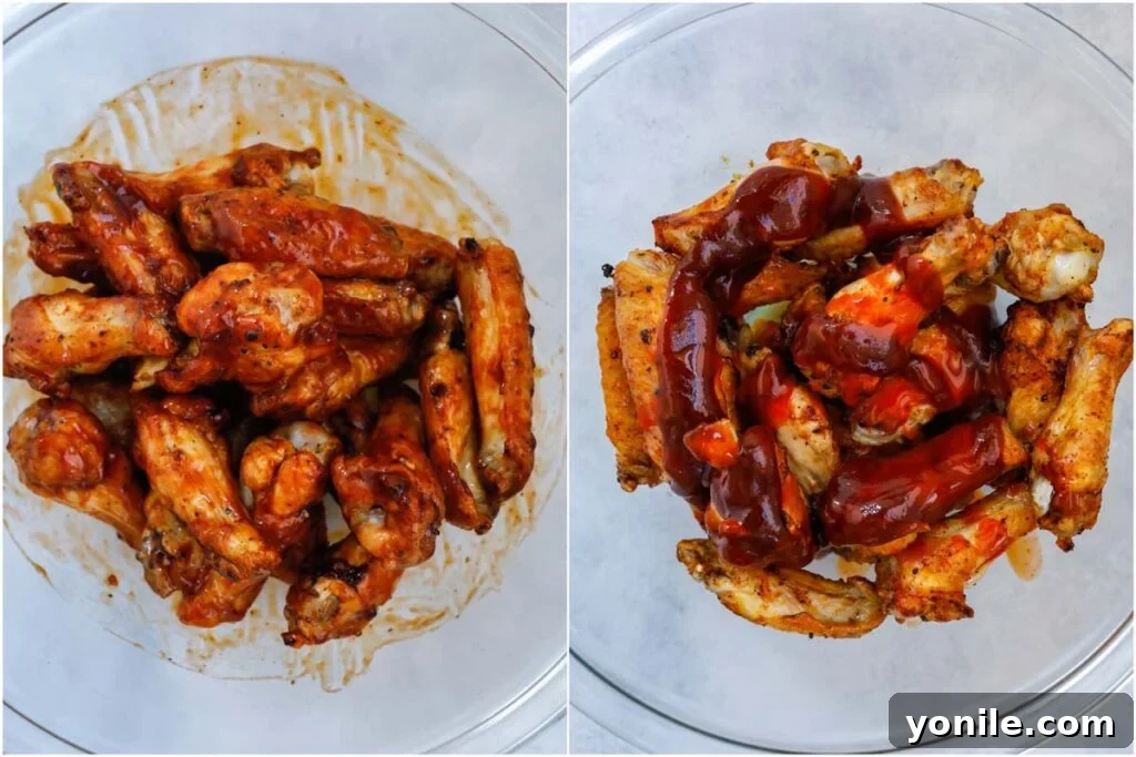 coating chicken wings in a bowl with BBQ sauce.