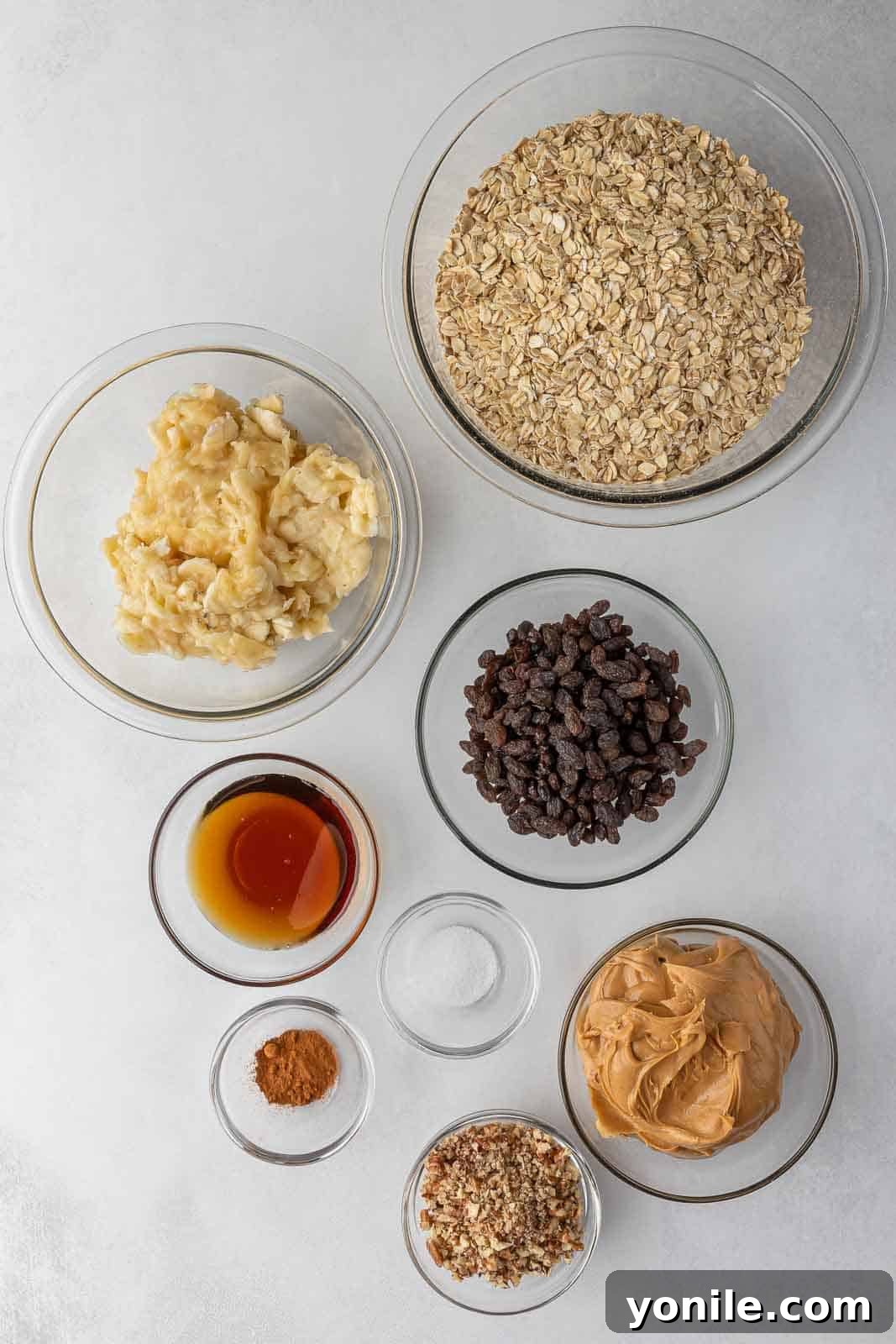 All the fresh ingredients needed for baking delicious cinnamon raisin oatmeal breakfast bars are laid out on a kitchen counter.