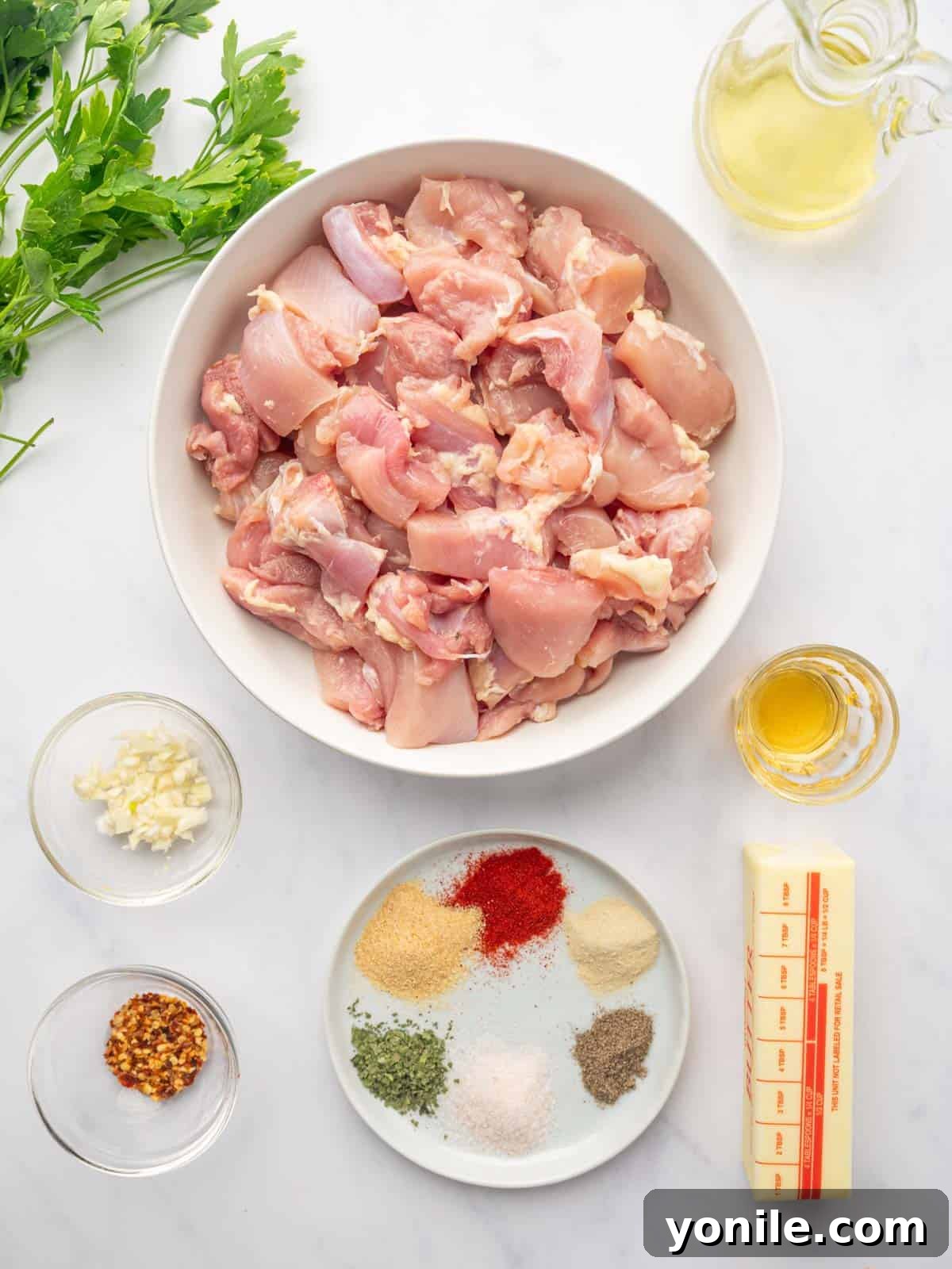 Ingredients needed for air fryer chicken skewers laid out on a white board.