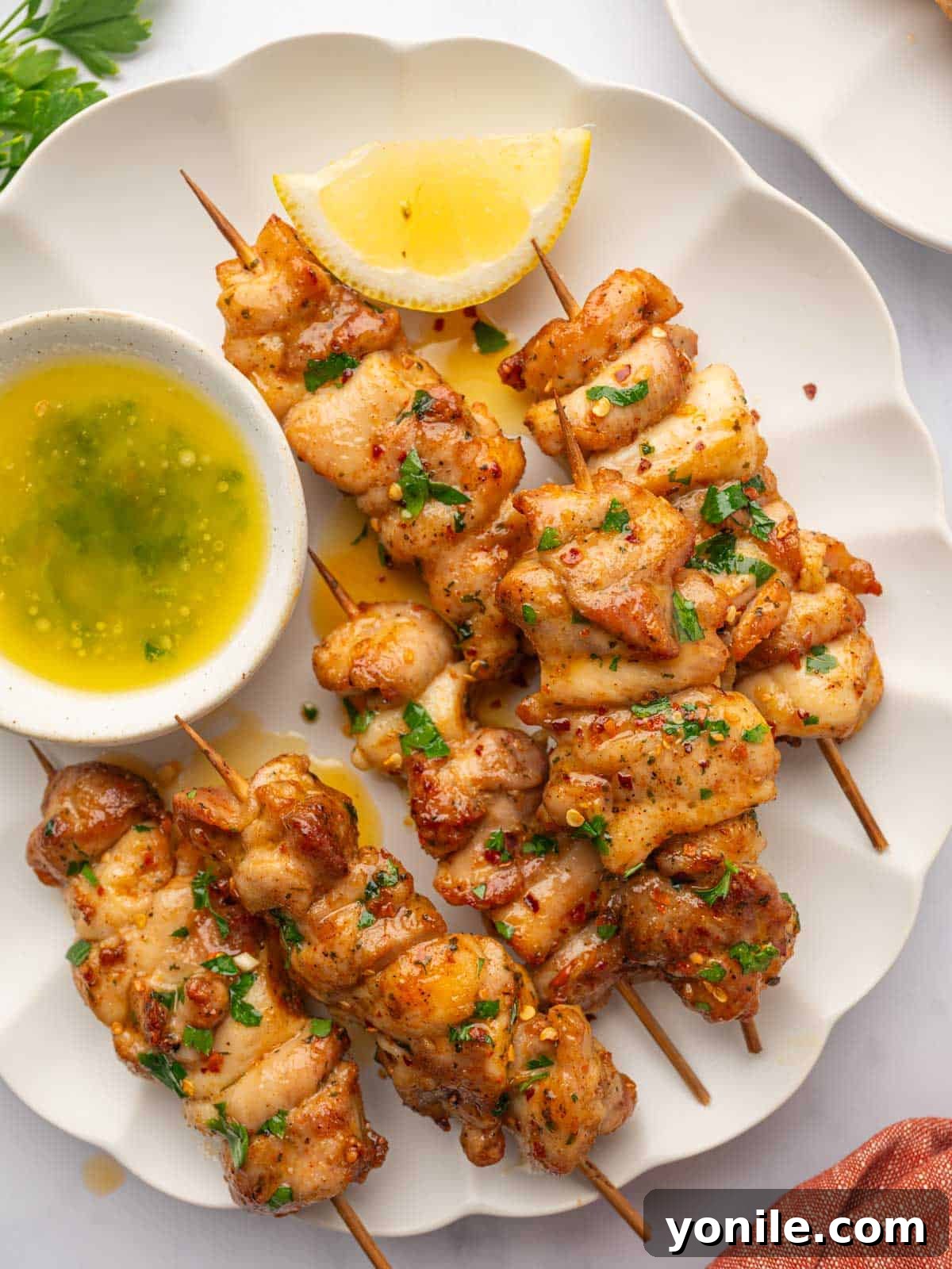 Close up of chicken skewers on a platter.