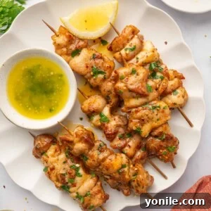 Chicken skewers on a plate.