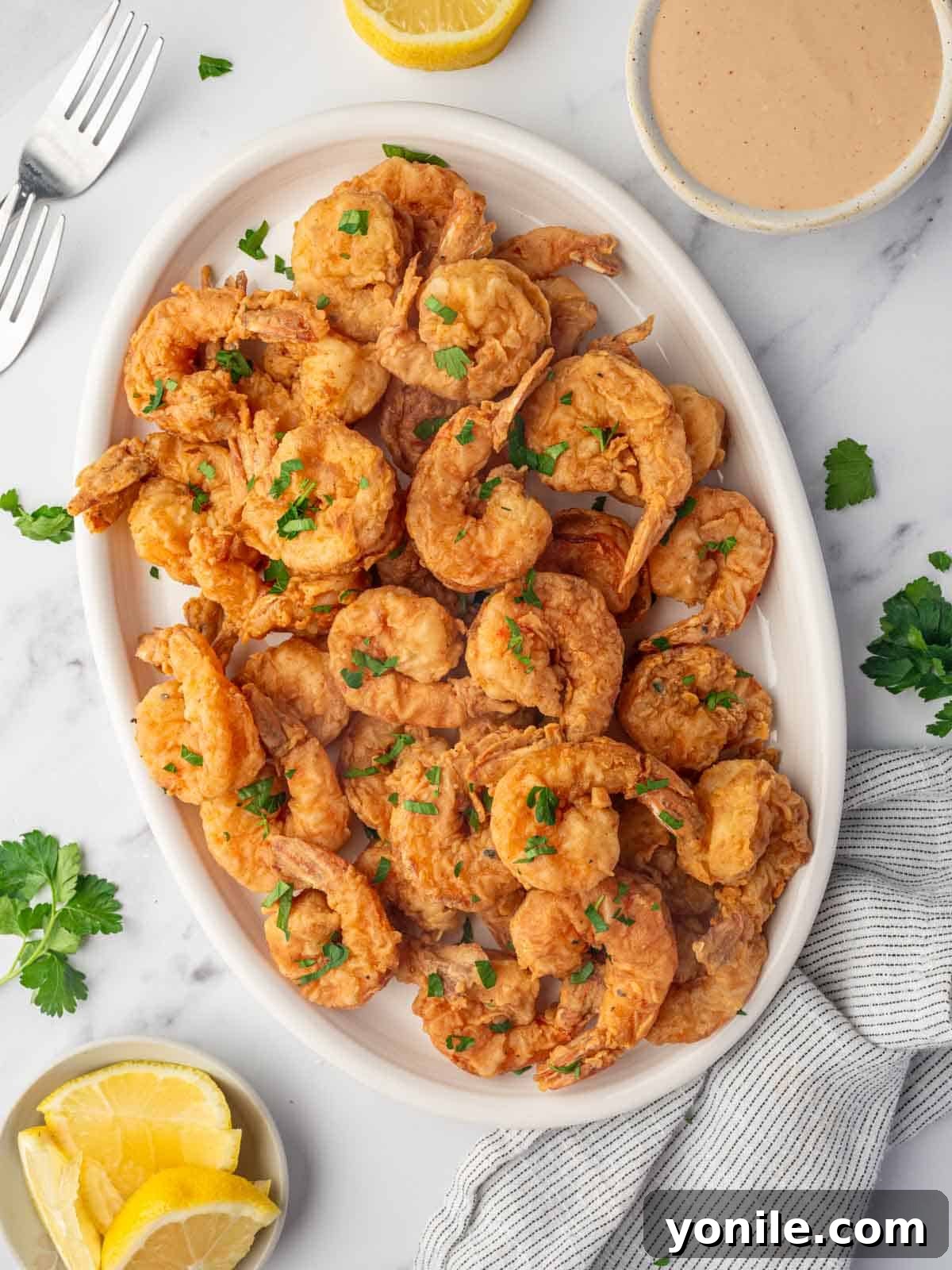 A platter of crispy shrimp with cajun seasoning.
