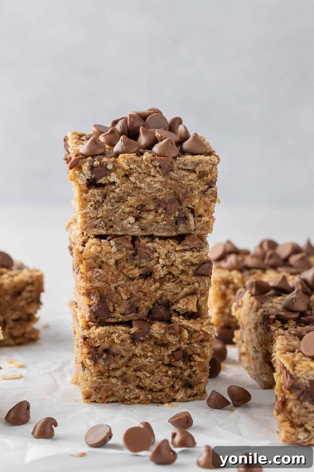 Chewy Chocolate Chip Peanut Butter Oatmeal Bars 9 Three chocolate chip peanut butter oatmeal bars in a stack.